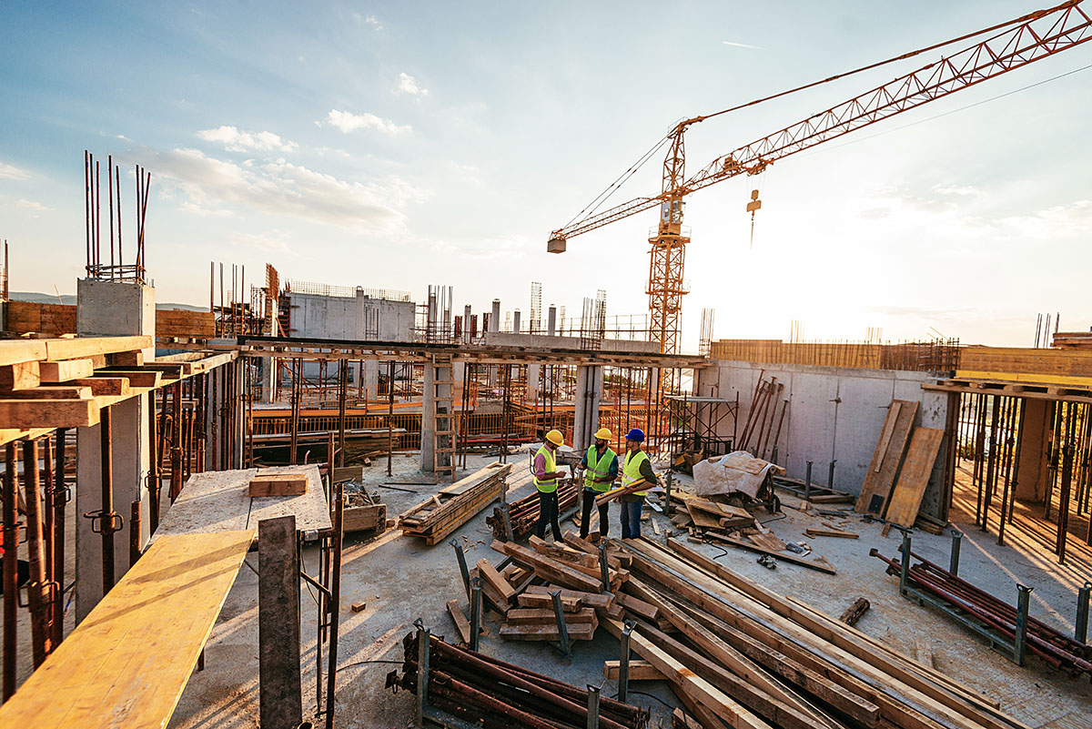 Three men at a construction site